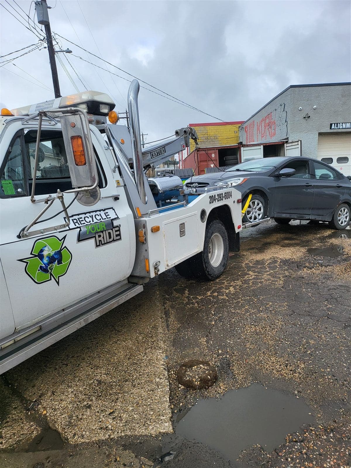 Recycle Your Ride tow truck collecting a grey car in Winnipeg
