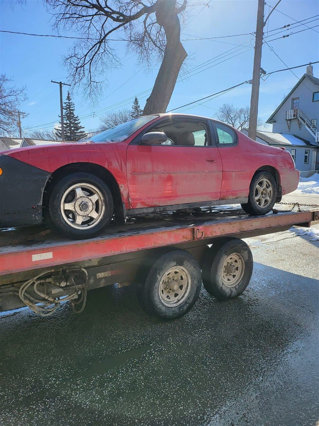 An unwanted vehicle loaded for pickup in Winnipeg